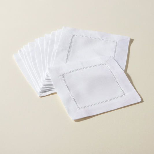 Set of white napkins with hemstitching on a white background