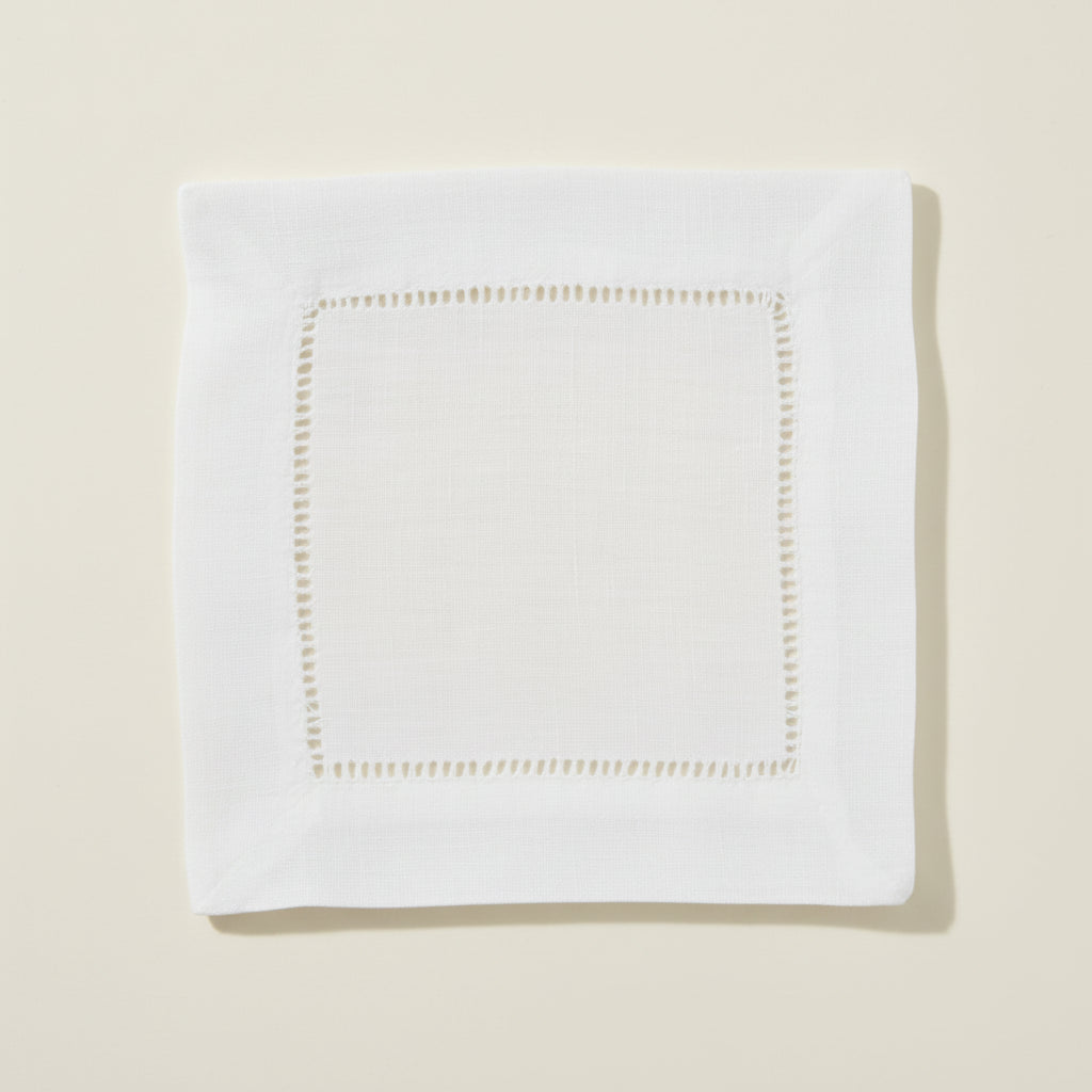 White hemstitch cocktail napkin on a white background