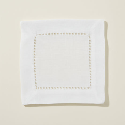 White hemstitch cocktail napkin on a white background