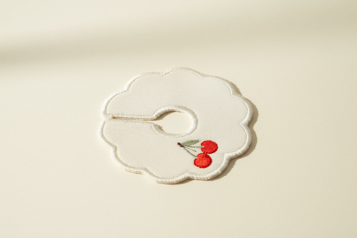 Decorative patch with cherries on a beige background