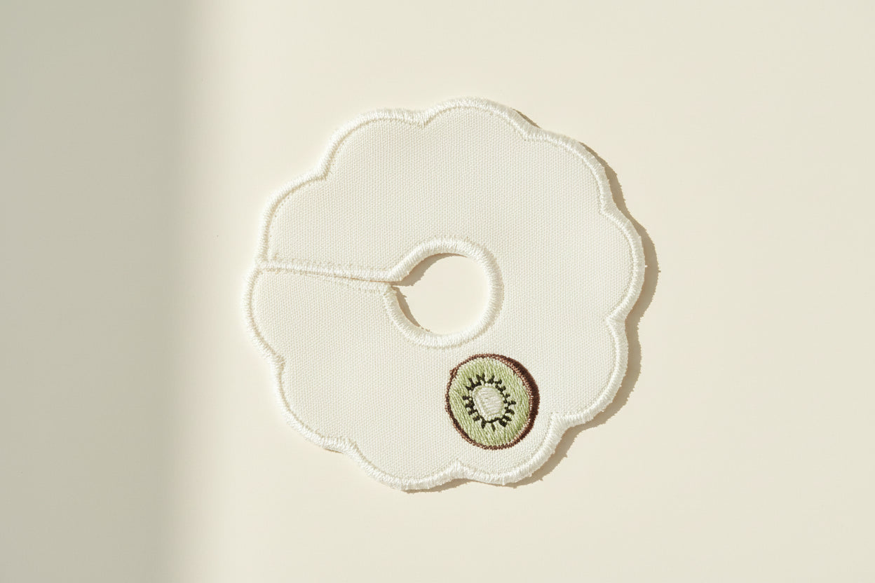White scallop patch with embroidered kiwi design