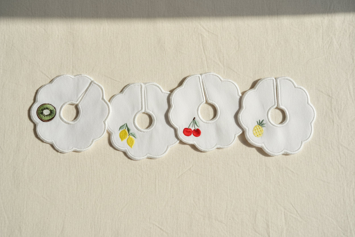 Four decorative patches with fruit illustrations on a beige background