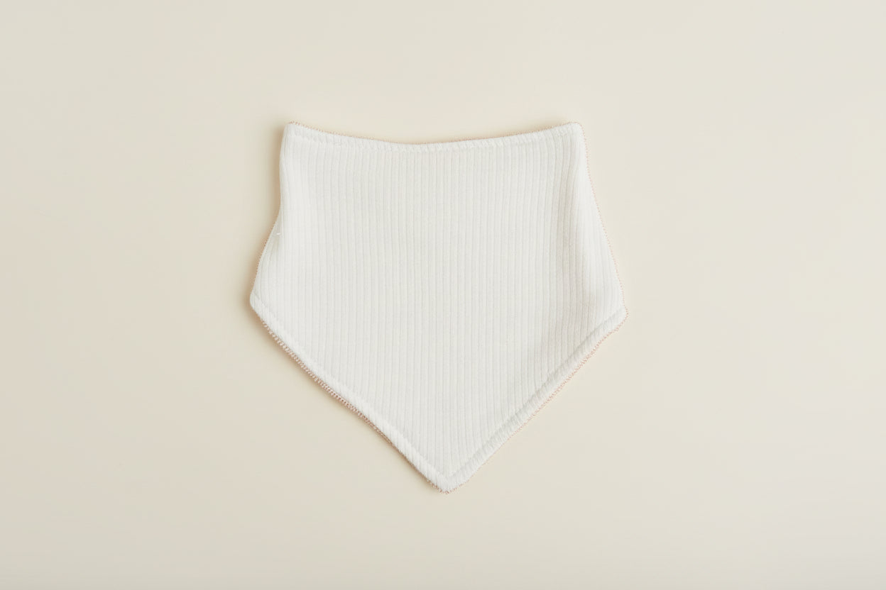 blue baby bib on a warm white background.
