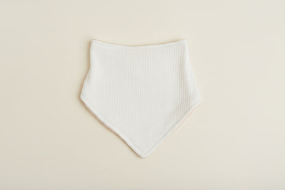 blue baby bib on a warm white background.