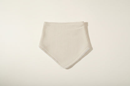 Light sage green baby bib on a warm white background.