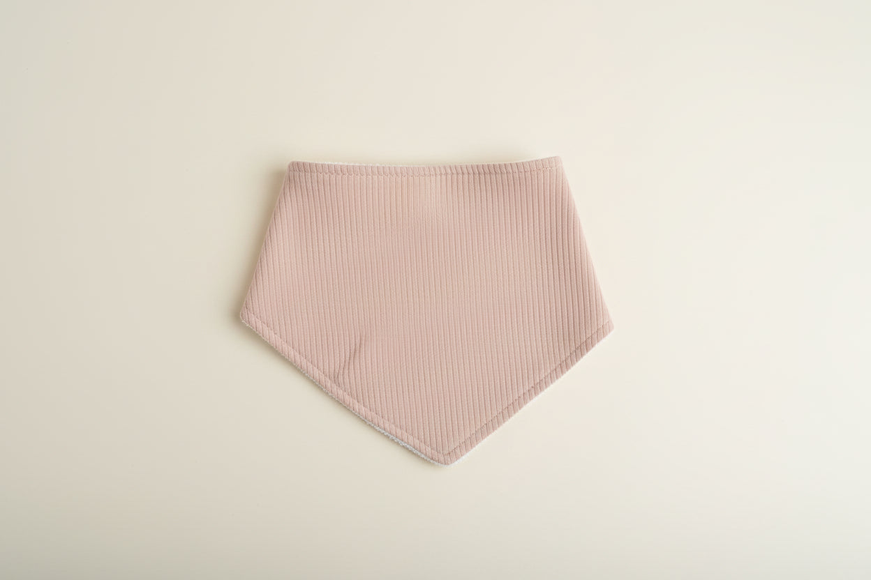 Dark Beige baby bib on a warm white background.