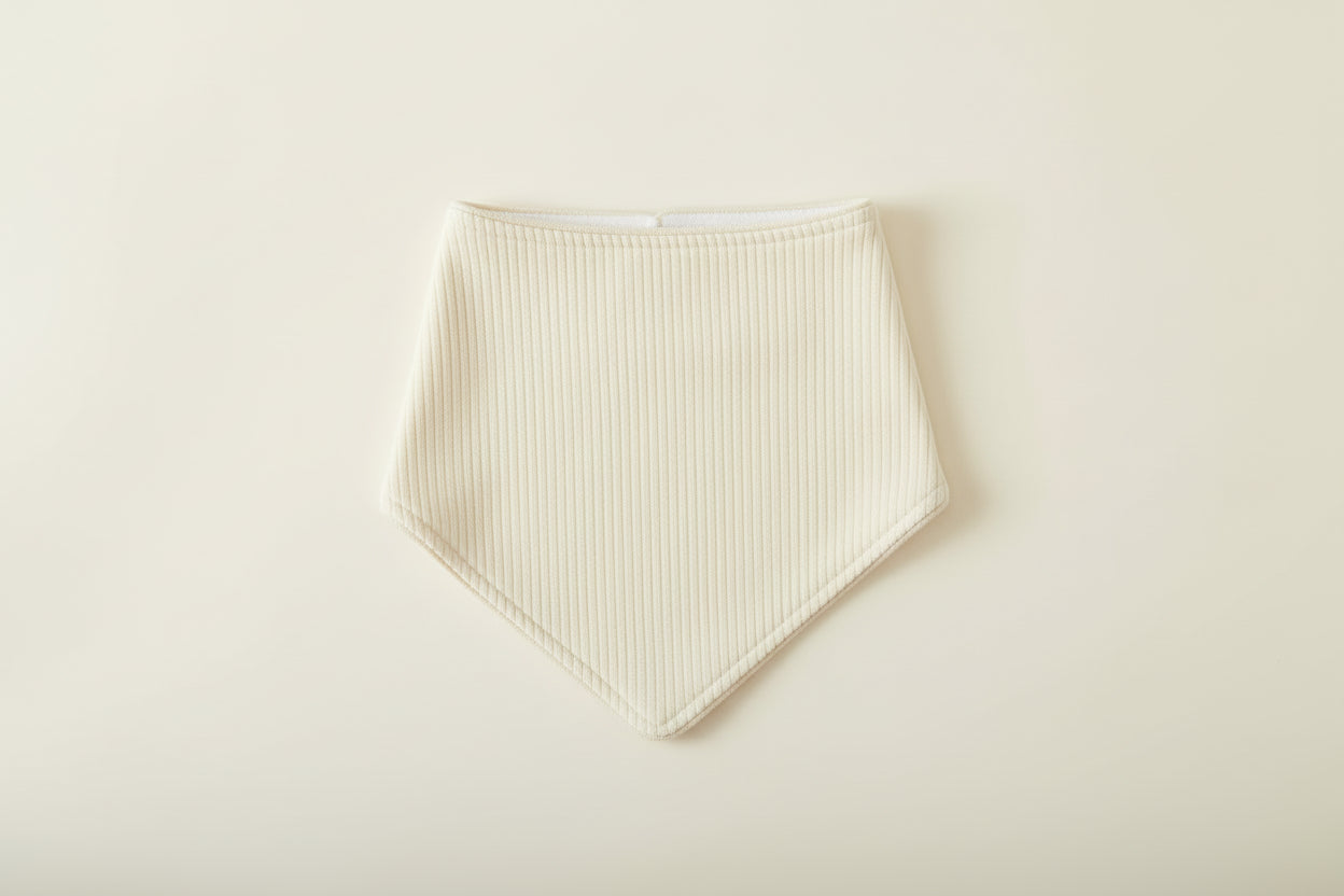 Light Beige baby bib on a warm white background.
