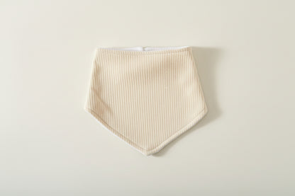 sage green baby bib on warm white background.