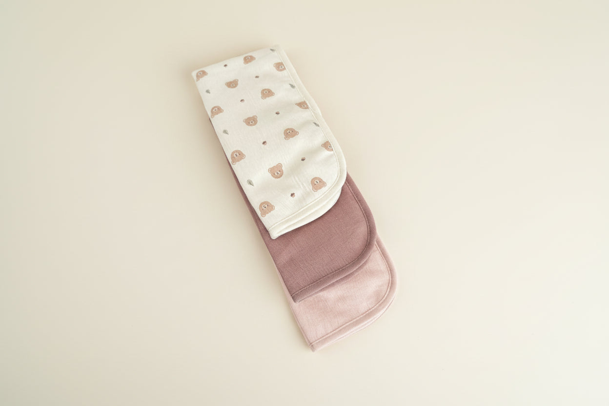 Set of three burp cloths with different colors and patterns.