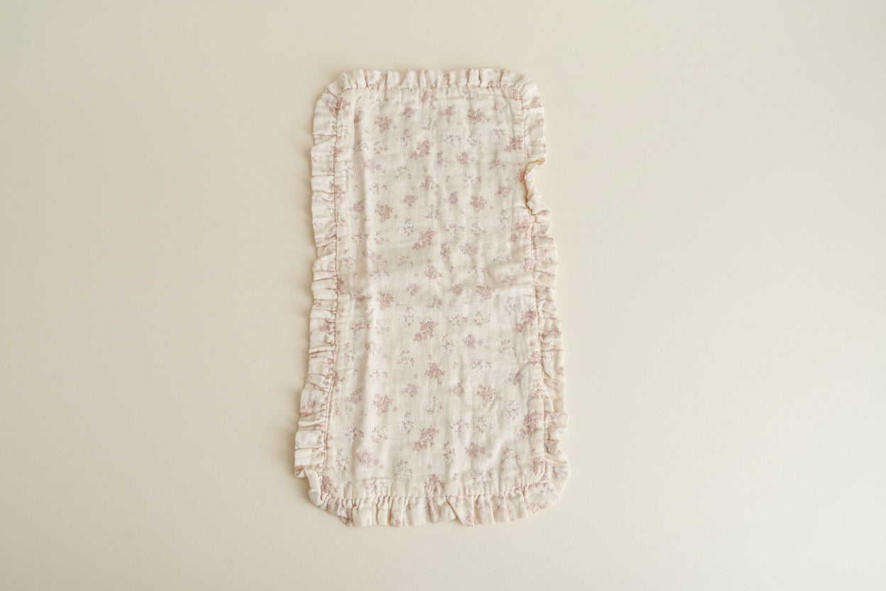 Floral-patterned burp cloth with ruffled edges