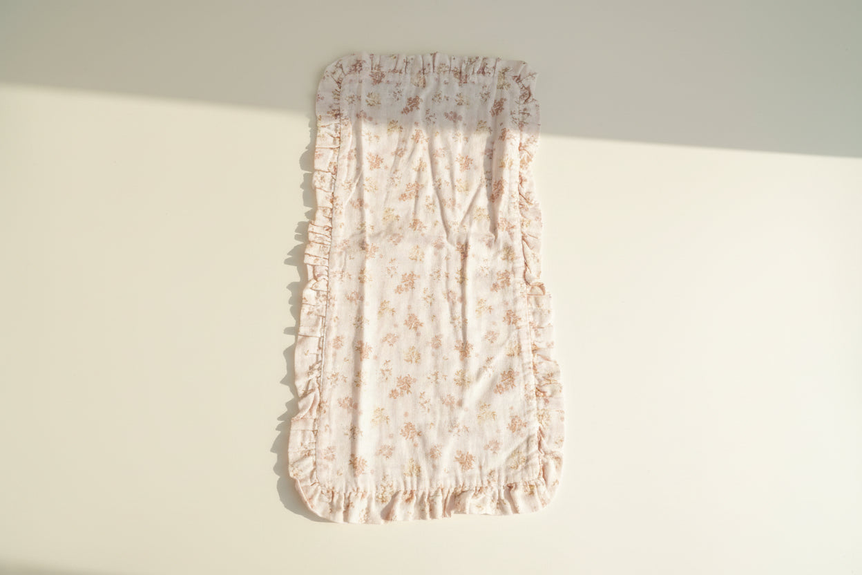 Floral-patterned burp cloth with ruffled edges