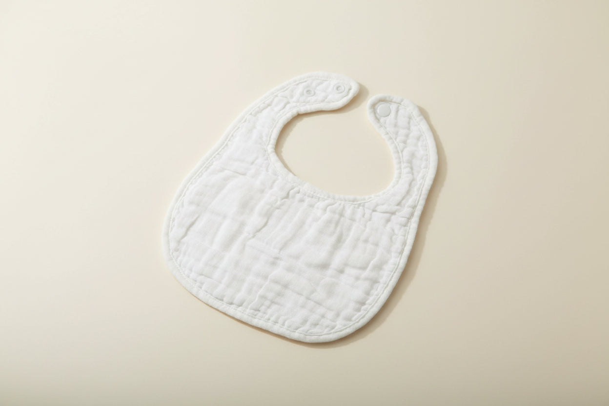 White baby bib on a wooden surface