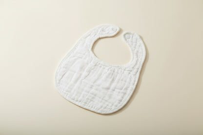 White baby bib on a wooden surface