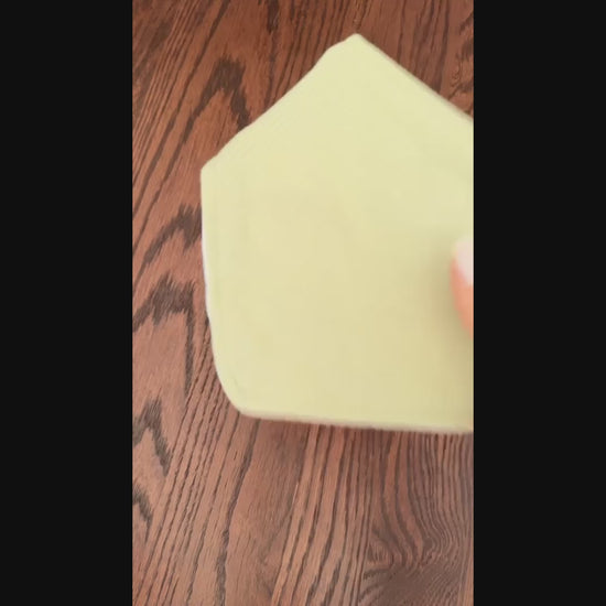 video set of 5 of colorful baby bibs on a wooden surface
