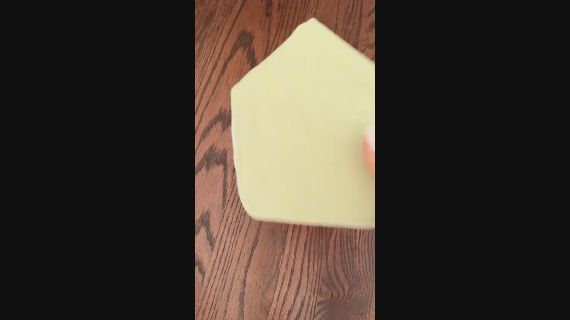 video set of 5 of colorful baby bibs on a wooden surface