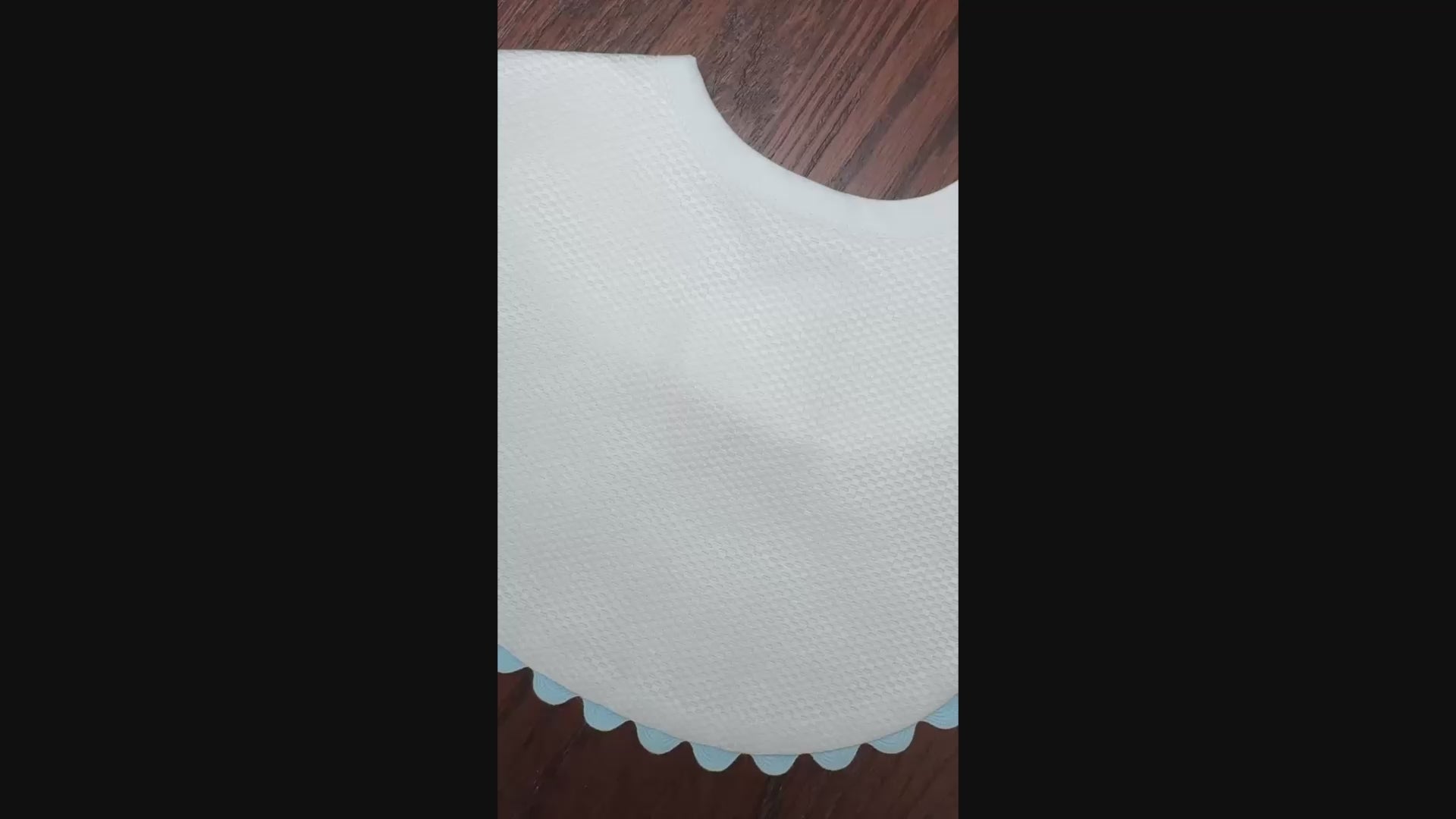 white with blue ric rac trim bib