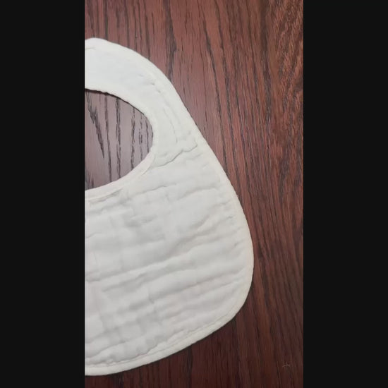 white muslin bib on wooden surface