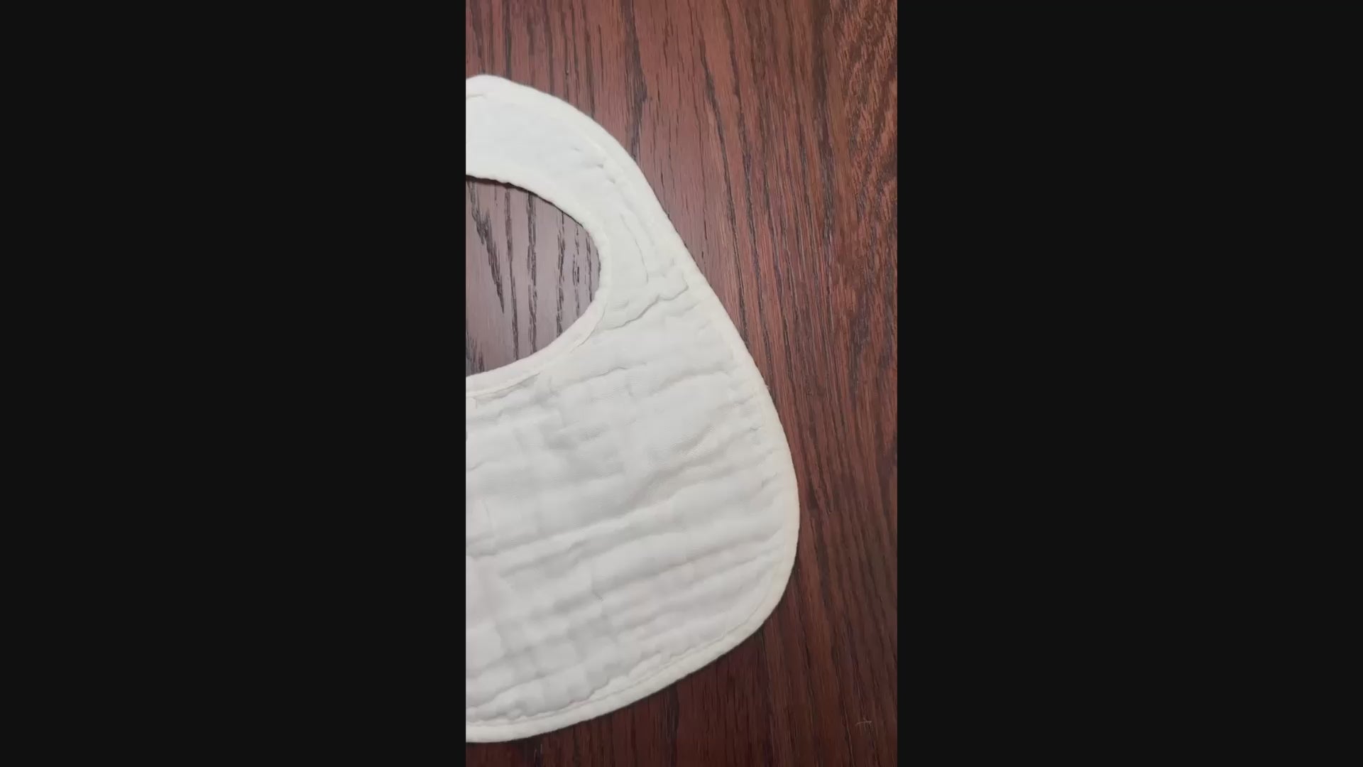 white muslin bib on wooden surface